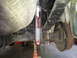 2003 Nissan Frontier - Underside view of a vehicle's rear suspension, showing a Rancho shock absorber and leaf springs.
