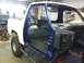 1982 Ford Bronco - A truck is undergoing restoration in a workshop, with its doors open and interior exposed.