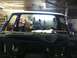 1982 Ford Bronco - Workshop view of a vehicle's unfinished interior, with tools and equipment in the background.