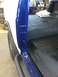 1982 Ford Bronco - Close-up of a vehicle's interior, highlighting the blue and white paintwork and floor.