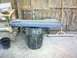 1982 Ford Bronco - A blue car door panel is placed on a trash can in a cluttered garage setting.