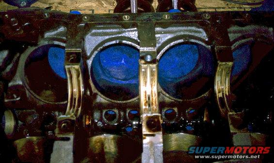 Engine block with blue pistons and connecting rods