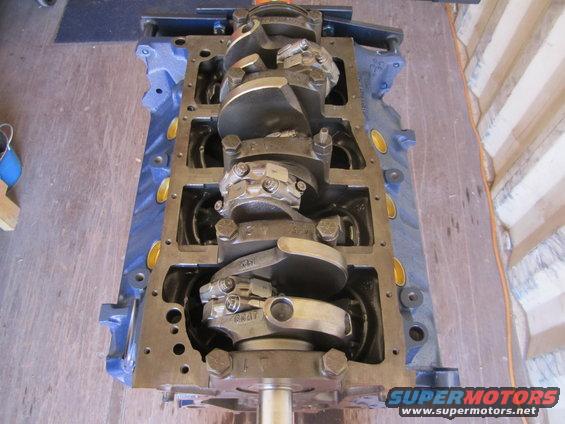 Ford V8 engine block with crankshaft installed. Some parts have numbers stamped on them