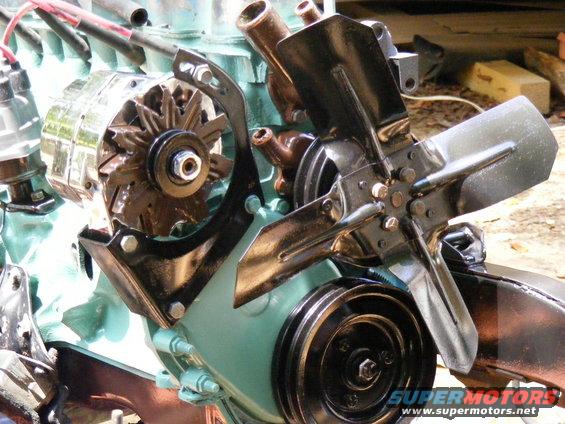 Close-up of an engine assembly with an alternator and fan