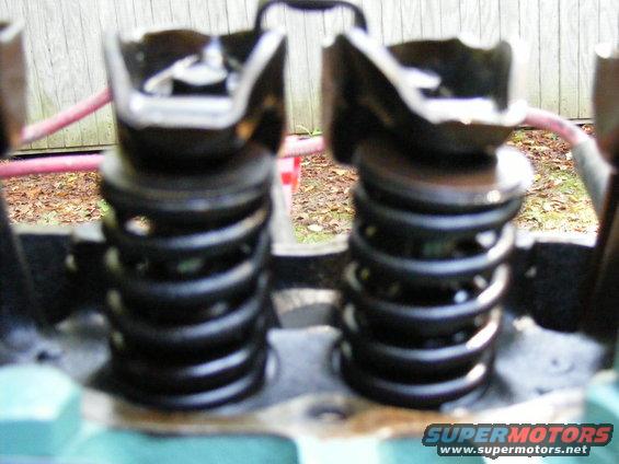 Close-up of two engine valve springs and their retainers