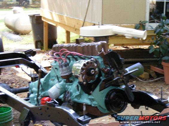 Teal engine on a black chassis with red spark plug wires