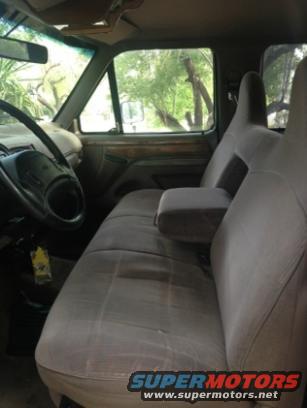 Interior of a 1992 Ford F-150 showing cloth seats, armrest, and dashboard