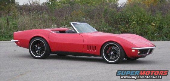 Red convertible sports car with black rims and red brake calipers parked on asphalt
