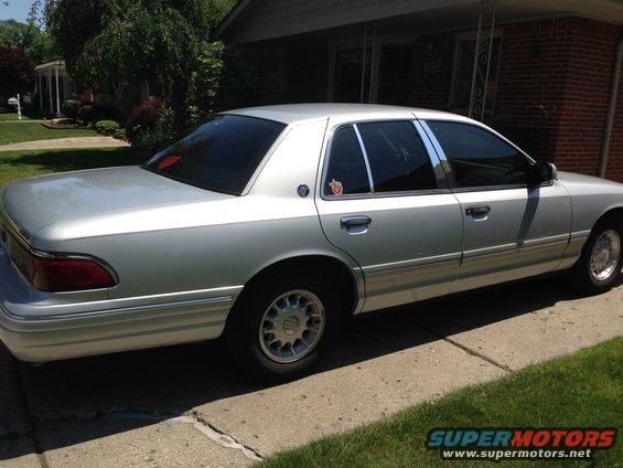 Silver 1995 Mercury Grand Marquis, side view. Badge on rear door