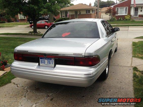 Rear view of a silver 1995 Mercury Grand Marquis parked in a driveway