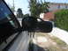 1997 Dodge 3500 - Side mirror assembly of a white vehicle parked outdoors.