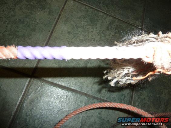 Rope with frayed ends and a section wrapped in purple tape
