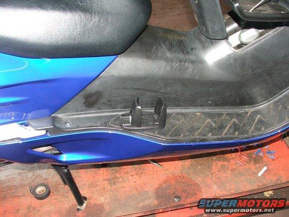Blue scooter floorboard with black textured grip and black footrest mounts