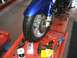 2006 Honda Reflex - Motorcycle front wheel and brake assembly with tools laid out on a service tray.