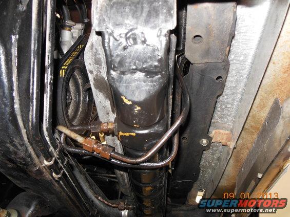Underside view of transmission cooler lines and part of a belt