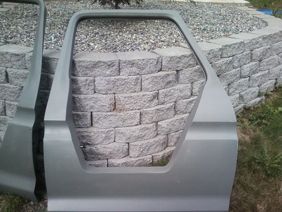 Gray car door with hexagonal window opening