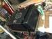 2004 Ford Crown Victoria - A custom fuel tank with a sump and dual fill necks sits on a workbench next to a welding machine.