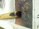 1989 Ford Bronco - A wooden part, possibly a handle or grip, is being worked on with grey putty over a newspaper.