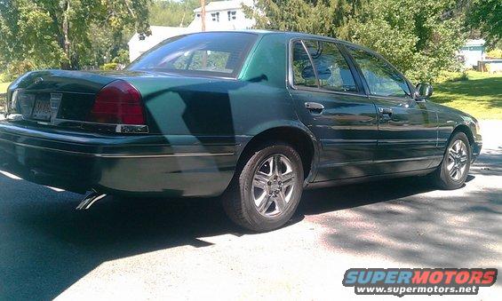 Green 2001 Ford Crown Victoria parked on asphalt, rear quarter view
