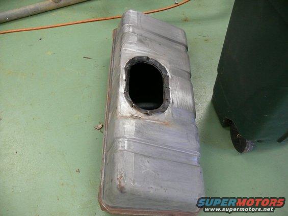 Metal fuel tank with a black gasket around an oval opening