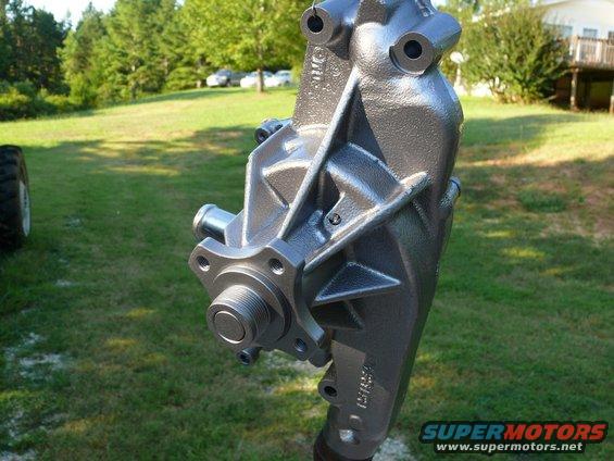 Gray metal water pump with threaded shaft and mounting holes, outdoors