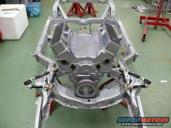 car frame with V8 engine and suspension parts