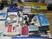2004 Aston Martin Virage - A variety of tools and hardware are laid out on a workbench, including a soldering iron, drill bits, and various clamps.