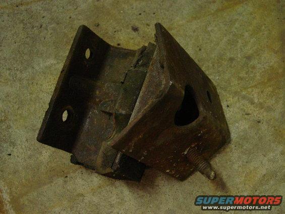 rusted engine mount bracket with a bolt sticking out, on a concrete floor