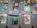 2004 Aston Martin Virage - Several Nintendo Entertainment System game cartridges are laid out, some with visible labels for popular games.