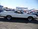 1973 Ford Ranchero - Side view of a white 1973 Ford Ranchero with its hood up at a car show.