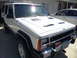 1973 Ford Ranchero - This white Jeep Cherokee XJ features aftermarket hood vents and is parked in a driveway.