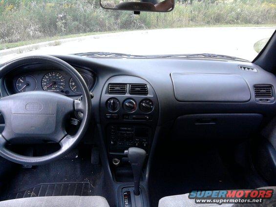 1995 Geo Metro interior showing dashboard, steering wheel, and center console