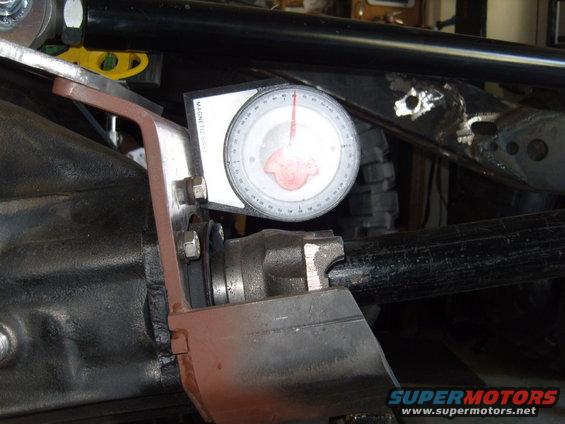 Gauge attached to a vehicle's axle, showing measurements