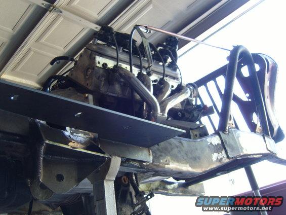 Engine and frame components being worked on, suspended from above
