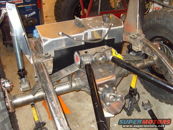 Custom fuel tank and suspension components on a vehicle frame