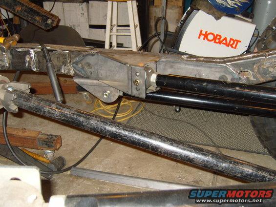 Hobart welding machine next to a vehicle frame with suspension components