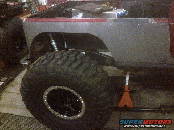 Jeep CJ body on jack stands with large off-road tires