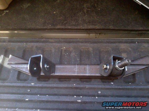 Custom fabricated suspension component with two mounting brackets and a threaded shaft marked 'LH'