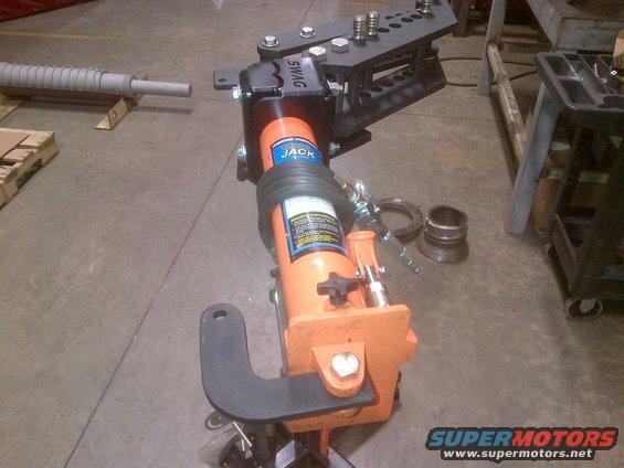 Orange hydraulic tube bender with black die set and SWAG label