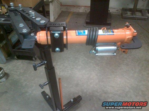 Tube bender with orange hydraulic ram and "SWAG" clamp