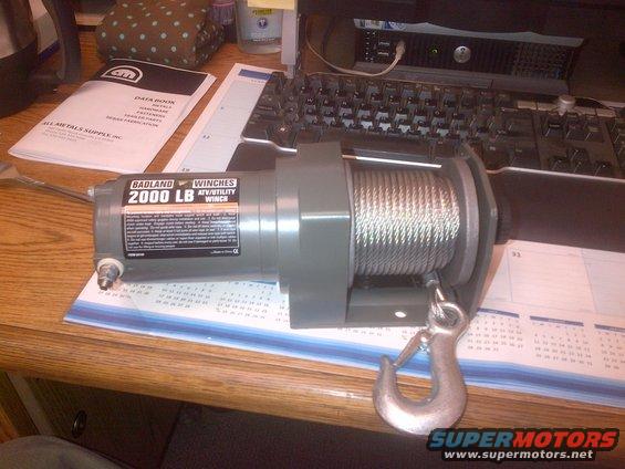 Badland 2000 LB ATV/Utility Winch with hook and cable on a desk