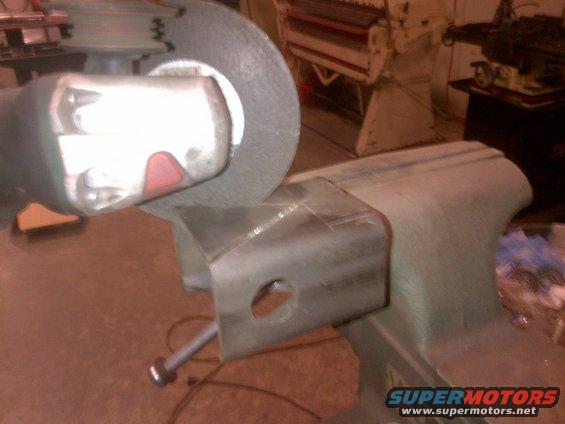 Angle grinder disc on metal part held in vise