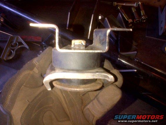 Engine mount part held by gloved hand