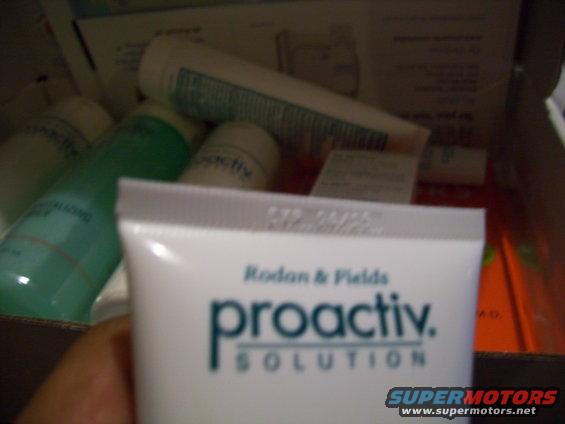 Box of Proactiv Solution skincare products with a hand holding one tube