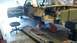 1964 Ford Fairlane - A 1964 Ford Fairlane is undergoing deconstruction, with its body raised on jacks and various parts removed.