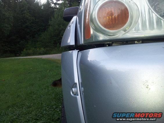 Silver truck front fender and headlight, 2003 Nissan Frontier