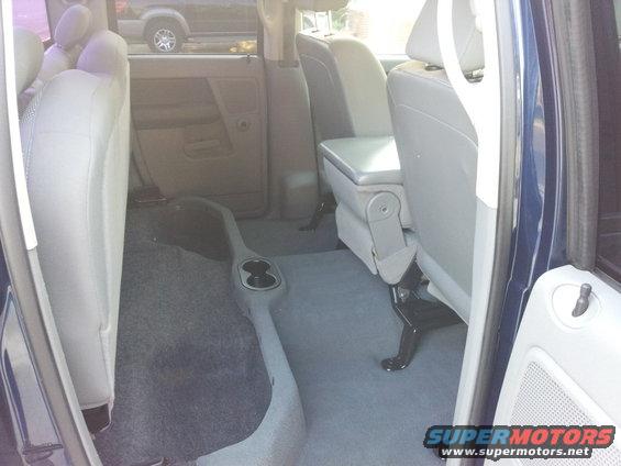 Inside of a vehicle, showing seats and door panel