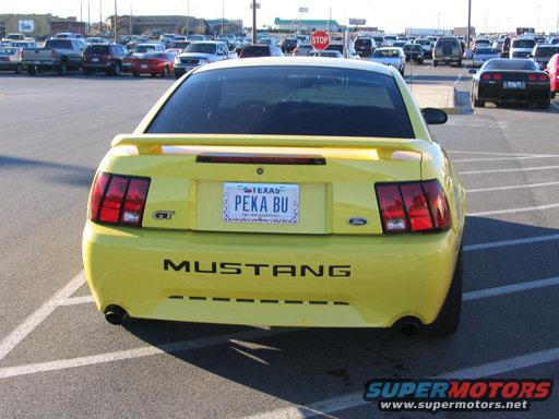 Yellow 2003 Ford Mustang GT rear view in a parking lot