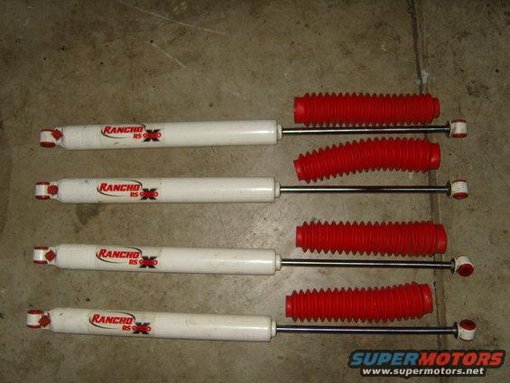 Four Rancho RS 9000 shock absorbers with red boots