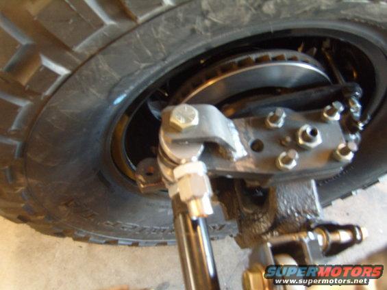 Close-up of a Jeep's front suspension with a disc brake rotor and caliper visible